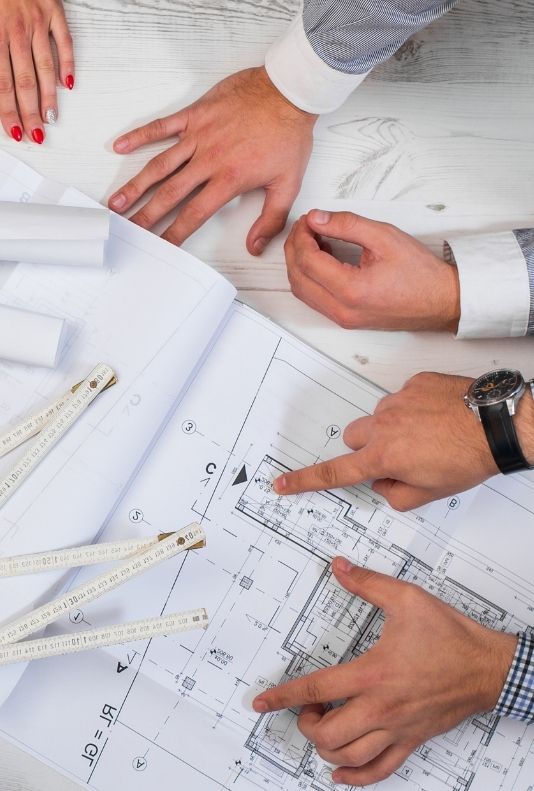 Owners pointing at an architectural plan.