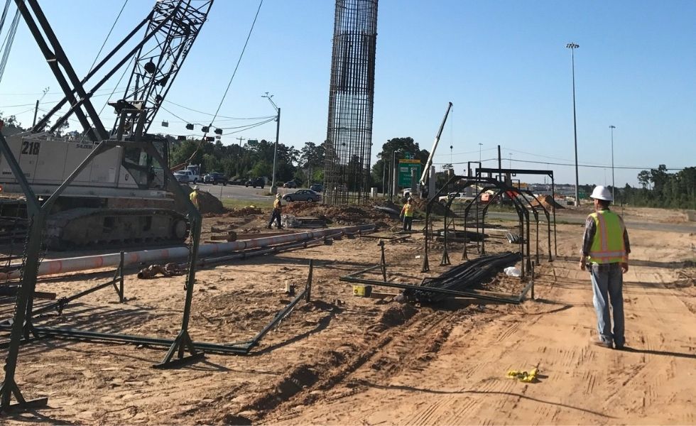 Workers installing steel rebar cages