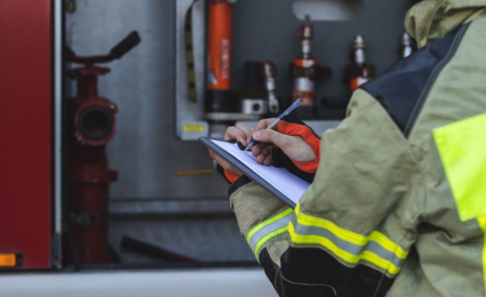 Fire protection professional documenting inspection