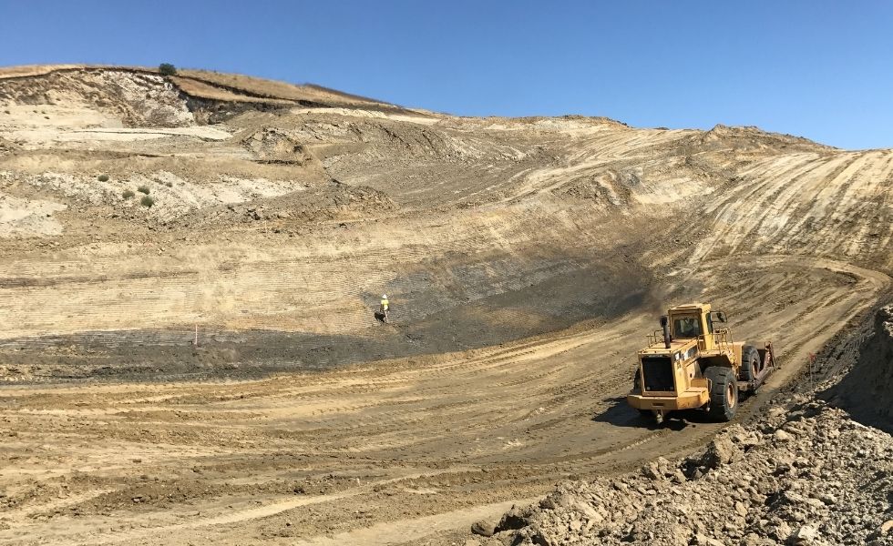 Wide view of large-scale earthworks with heavy machinery