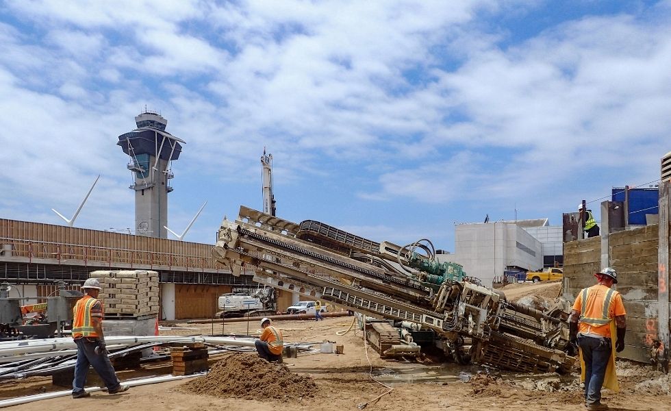 Workers operating a horizontal drilling machine for deep foundation