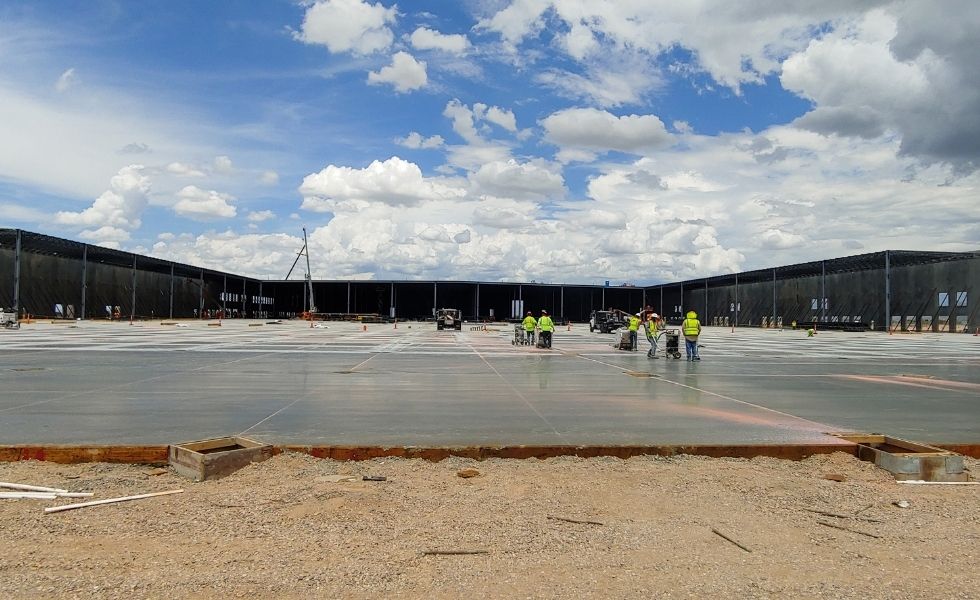 Ground-level view of workers performing concrete slab