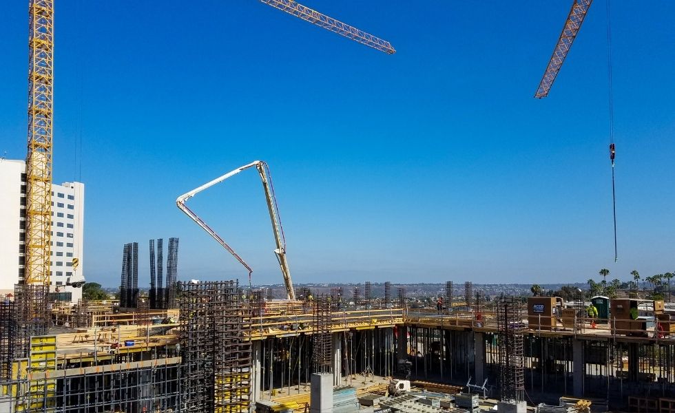 Aerial view of a construction site showing concrete slab installation with formwork