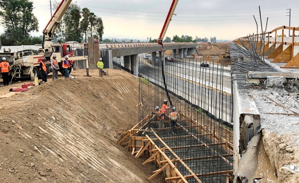 Construction crew working on bridge foundation with rebar installation