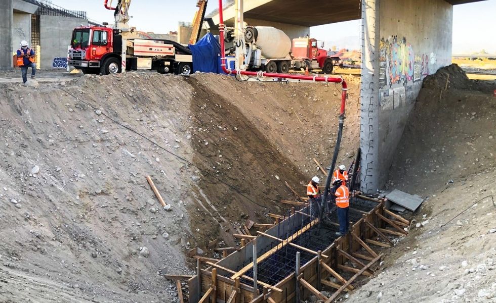 Construction workers installing rebar and formwork