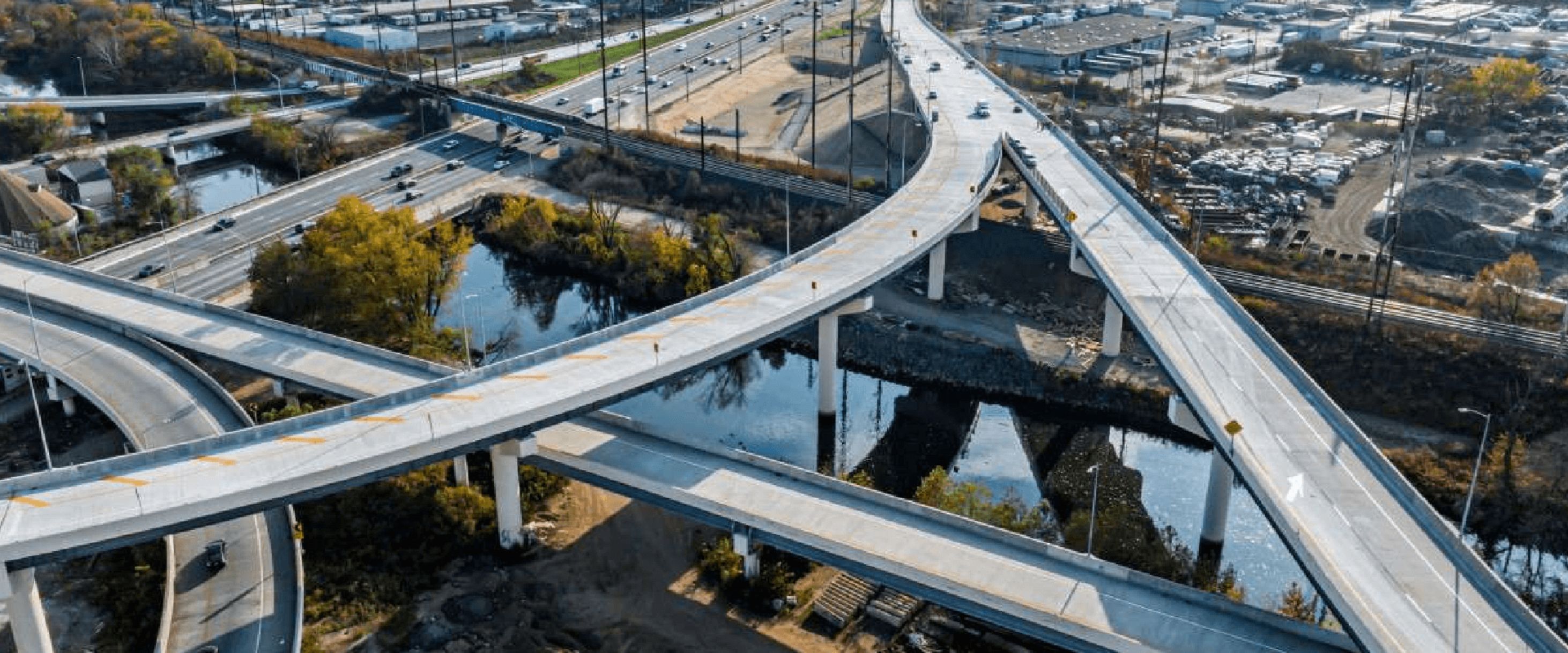 Betsy Ross Interchange Improvements - Aerial view of a multi-level highway interchange ith elevated bridge ramps over a river