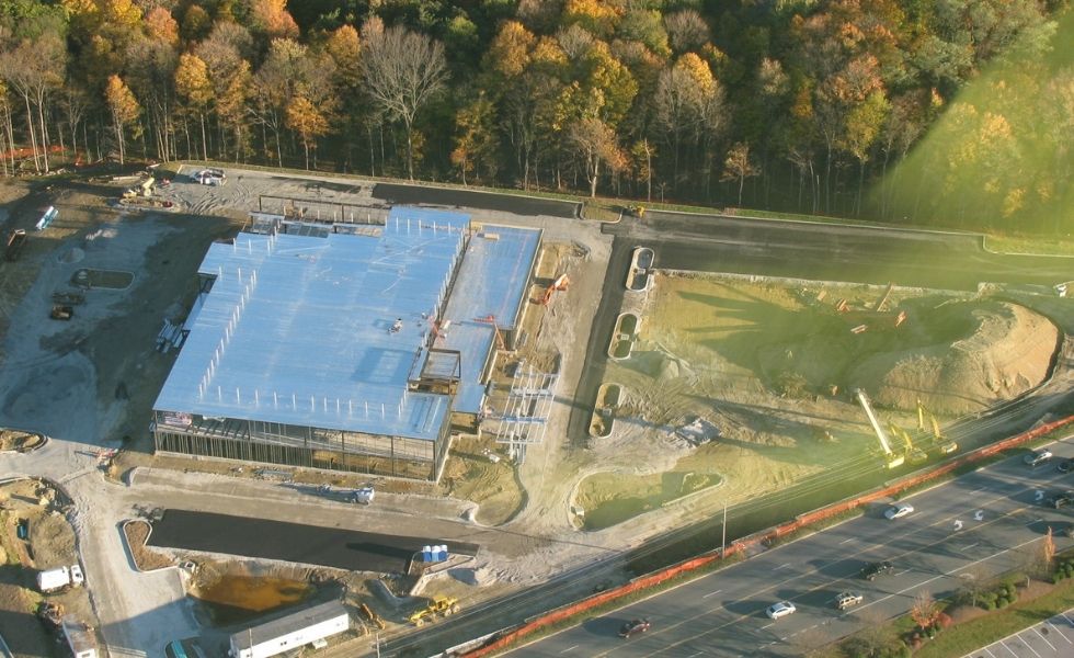 Aerial view of the Crystal Run Healthcare facility under construction in New York, showing site development, structural framing