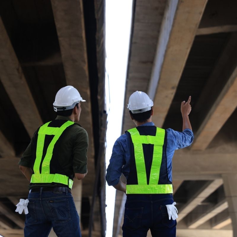 Construction inspectors conducting a bridge structure inspection beneath an overpass as part of the I-90 – SR