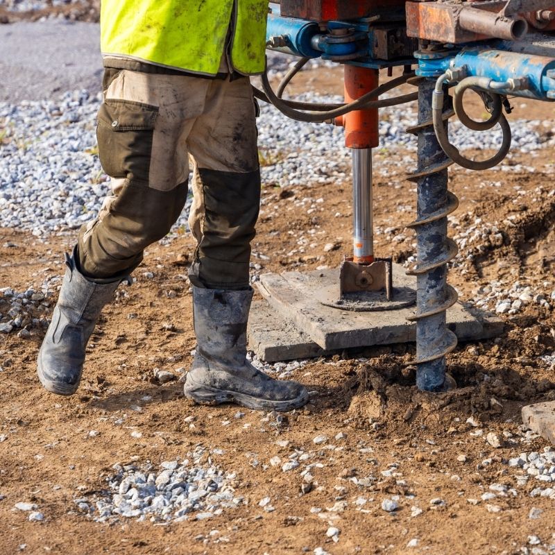 Close-up of a geotechnical drilling rig performing a soil boring test at a construction site, collecting subsurface data to evaluate soil conditions - Webinar Geotechnical Reports In Florida