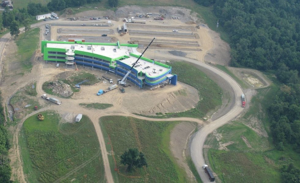 Aerial photograph of the Mediacom Corporate Headquarters construction site in New York showing the curved, multi-story office building during development.