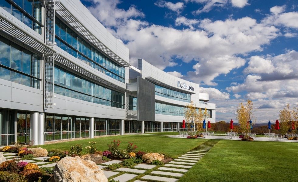 Exterior view of the completed Mediacom Corporate Headquarters in New York featuring a modern curved glass and metal façade.