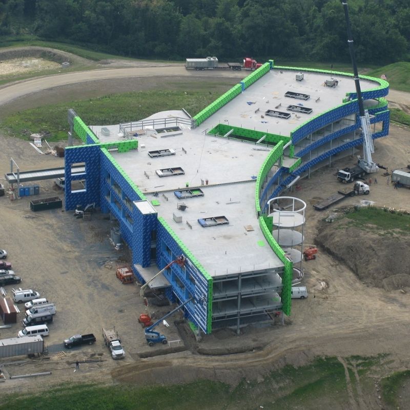 Mediacom Corporate Headquarters, NY: aerial view of the corporate headquarters under construction, showing the structural frame, exterior wall installation, and active site development.