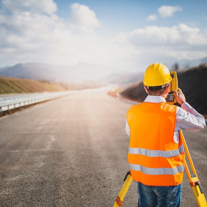 SR 3002 Culvert Replacement, PA: survey professional performing field measurements along a roadway to support infrastructure planning, environmental coordination, and culvert replacement design.