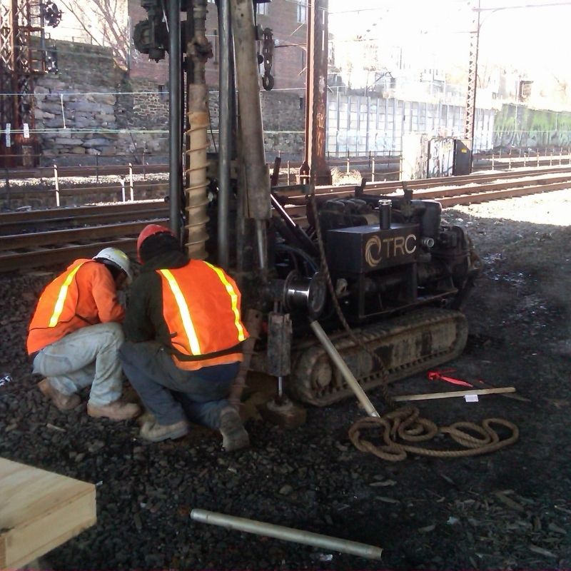 41st Street Bridge project: geotechnical drilling equipment and field personnel conducting subsurface investigation activities adjacent to active railway tracks.