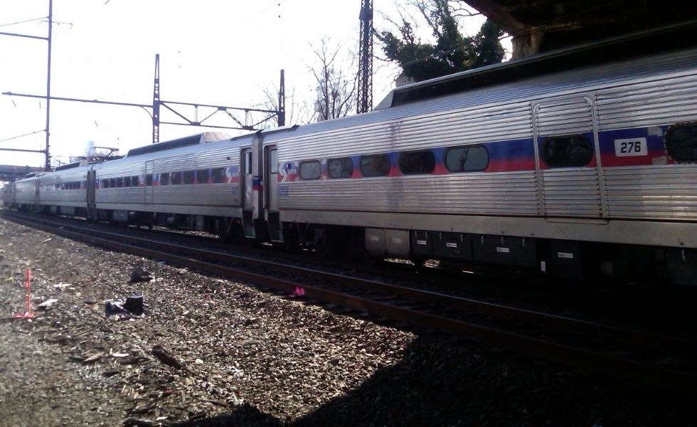 41st Street Bridge project: geotechnical fieldwork taking place within an active rail corridor, with drilling operations being performed near passing passenger rail traffic