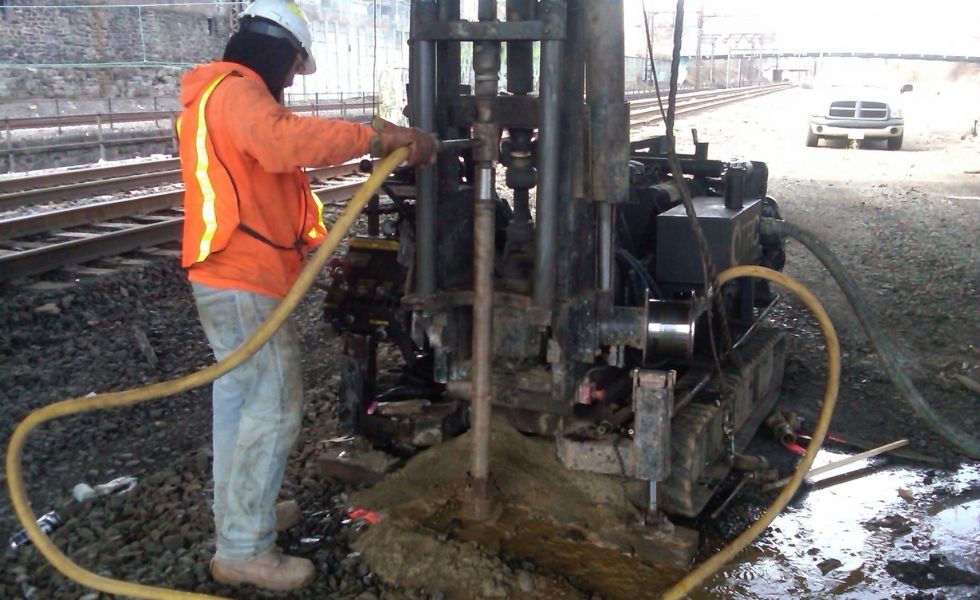 41st Street Bridge project: field technician operating drilling equipment during subsurface investigation and soil sampling activities beneath the bridge corridor.