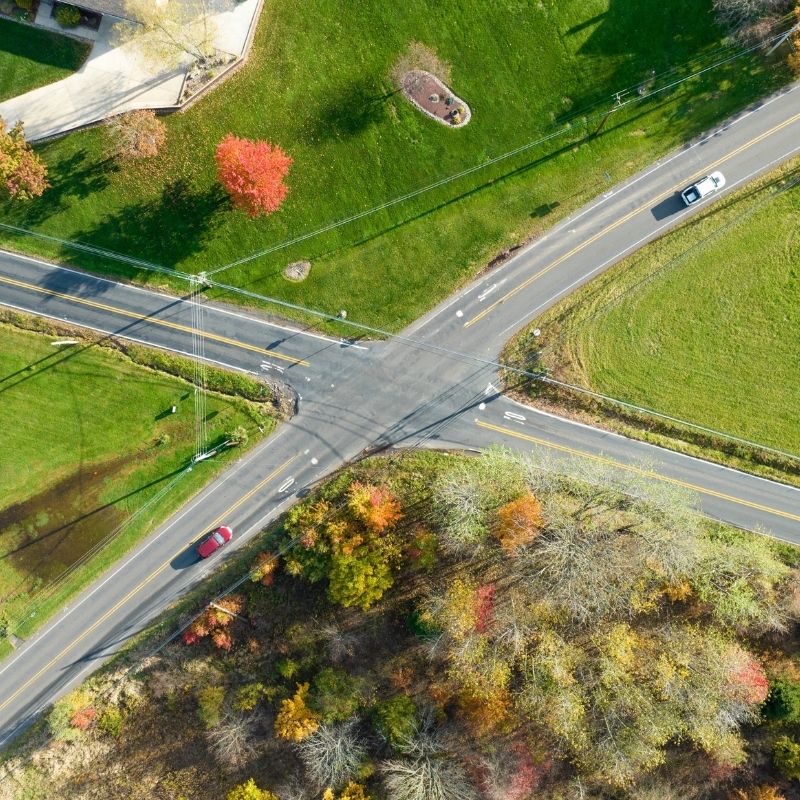 Aerial view of the Old Bethlehem Pike/Portzer Road Roundabout project area before roundabout construction, showing the existing four-way roadway intersection, surrounding residential