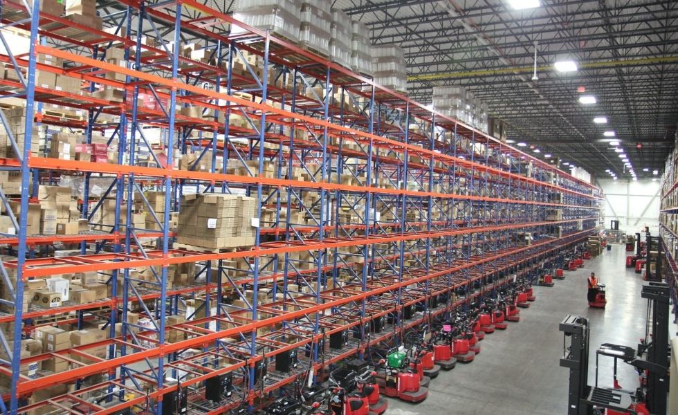 High-bay warehouse storage system inside the United Natural Foods Distribution Facility featuring multi-level pallet racking, automated material handling equipment.
