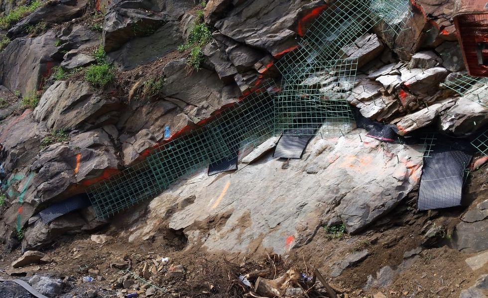 US 11/15 Rock Slope Safety Improvement, PA project: close-up view of rock slope stabilization work, including reinforcement mesh and rockfall mitigation components installed on the rock face.