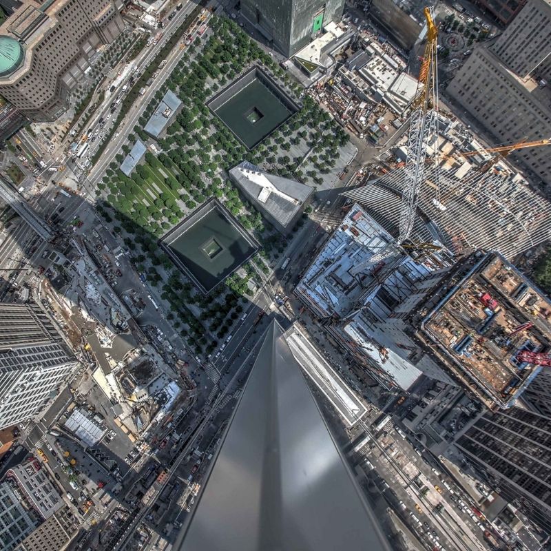 Aerial view of The Reconstruction of the World Trade Center Complex, NY, showing the 9/11 Memorial reflecting pools, surrounding redevelopment, active construction areas.