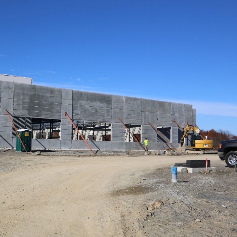 Blackhawk / McKesson Corporation Distribution Center under construction, showing concrete wall panels, structural framing, and construction equipment.