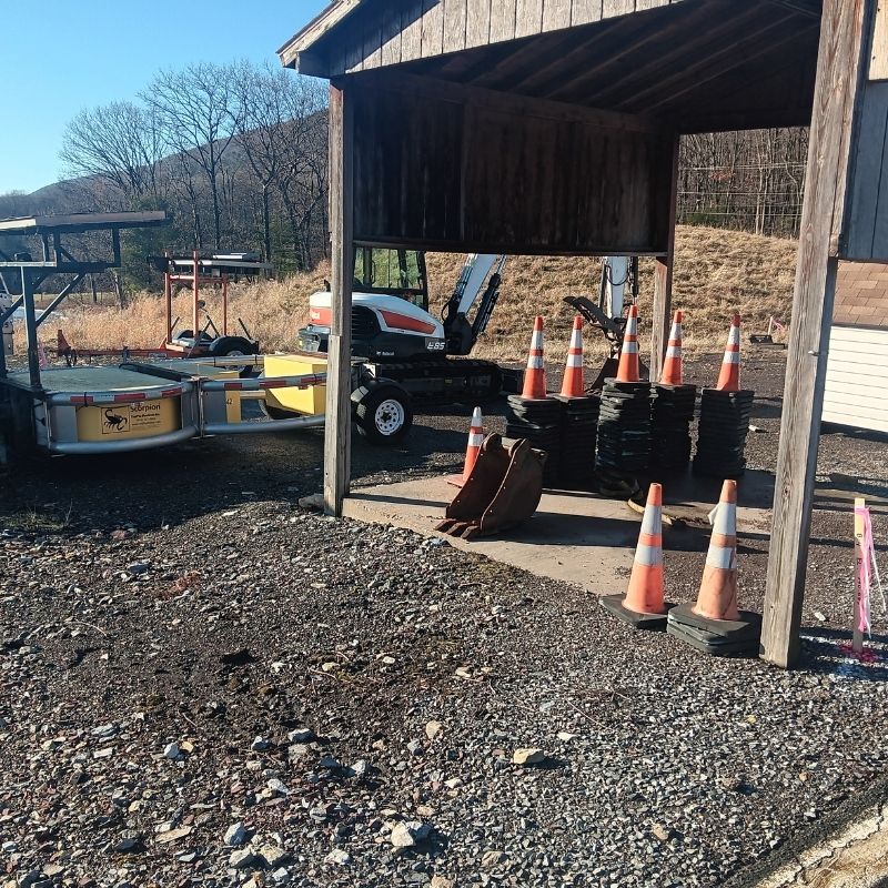 Geotechnical field equipment, traffic control cones, and utility investigation tools staged at a project site for the Open-End Geotechnical Services Contract