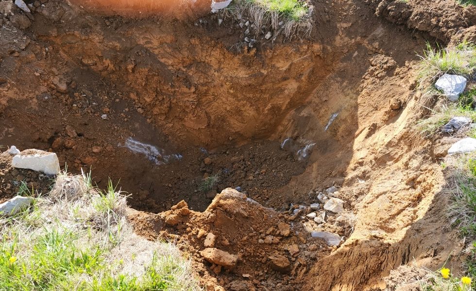 Excavated sinkhole investigation area documented as part of the Open-End Geotechnical Services Contract, showing exposed soil and subsurface conditions