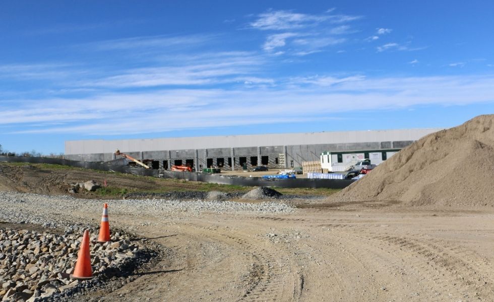 Project Blackhawk / McKesson Corporation Distribution Center under construction, showing the warehouse exterior and surrounding undeveloped landscape.