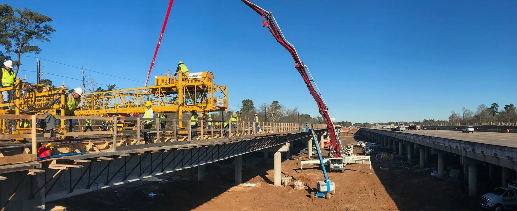 Bridge construction work above a highway