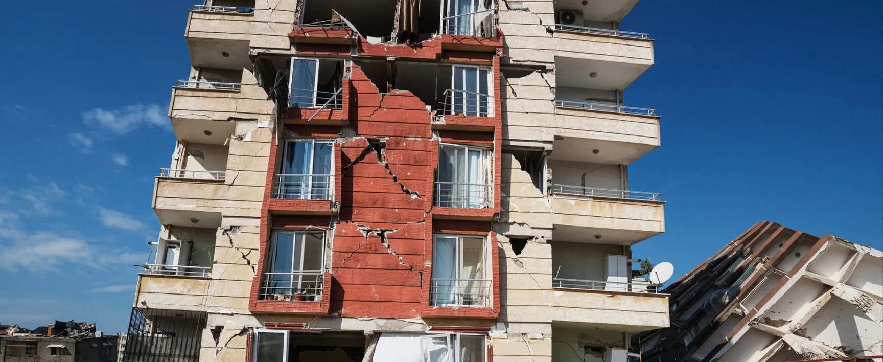 Cracked apartment building facade showing structural damage