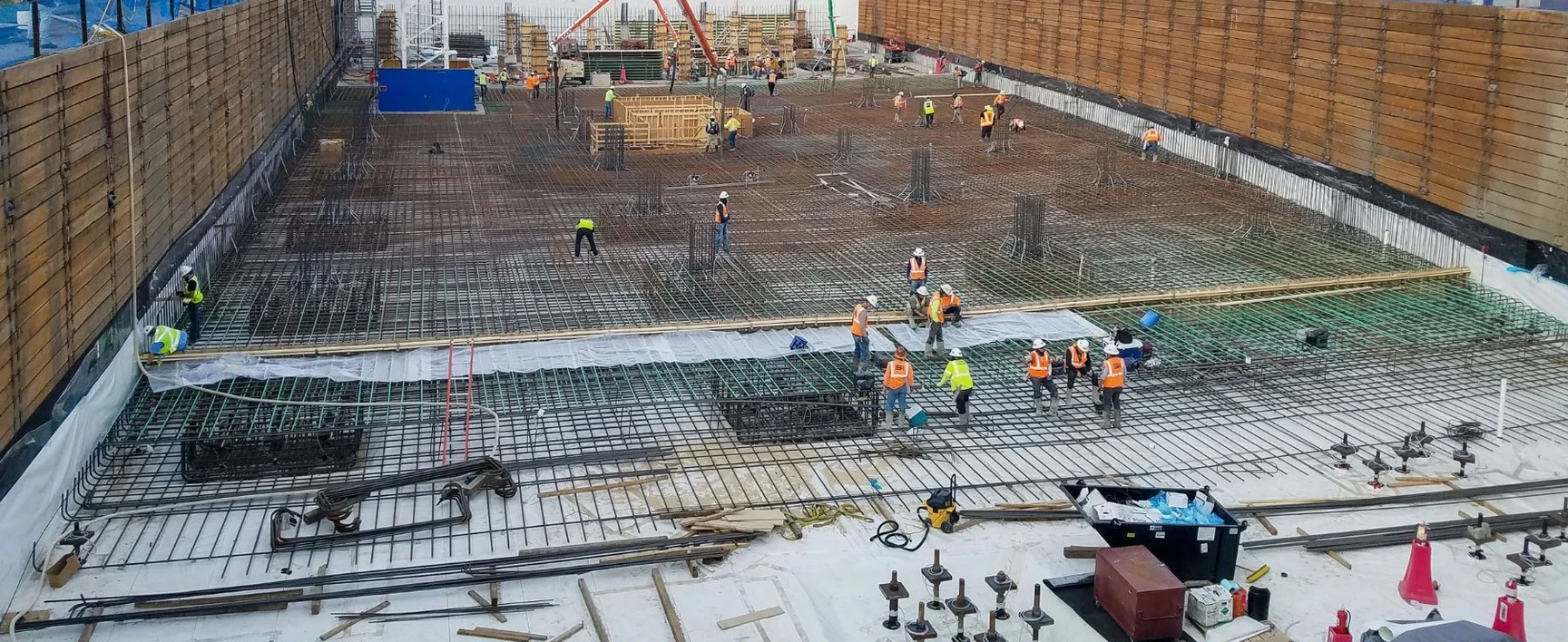 Construction workers installing steel reinforcement