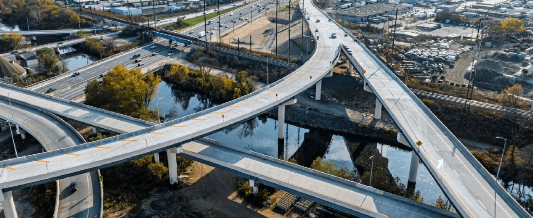Betsy Ross Interchange Improvements - Aerial view of a multi-level highway interchange ith elevated bridge ramps over a river