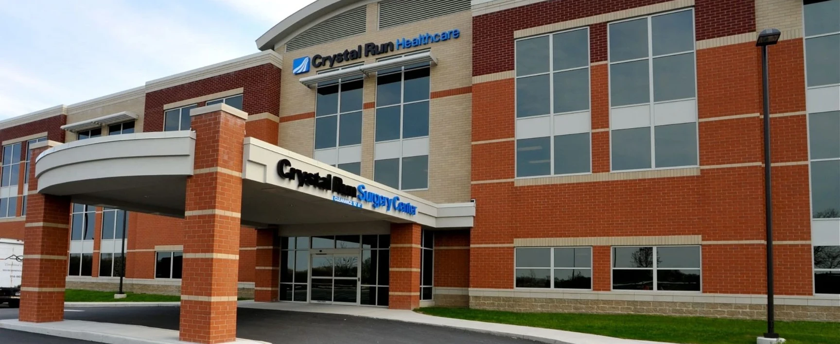 Main entrance of the Crystal Run Healthcare Surgery Center in New York, showcasing the covered drop-off area