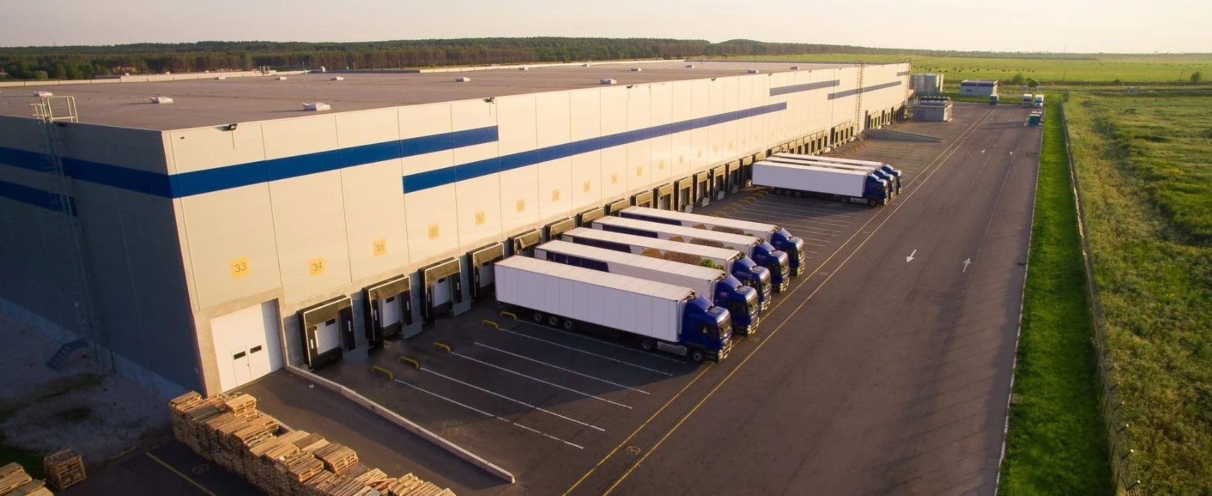 The Old Navy Distribution Center, featuring a large logistics warehouse with multiple loading docks and several tractor-trailers positioned for loading and unloading.