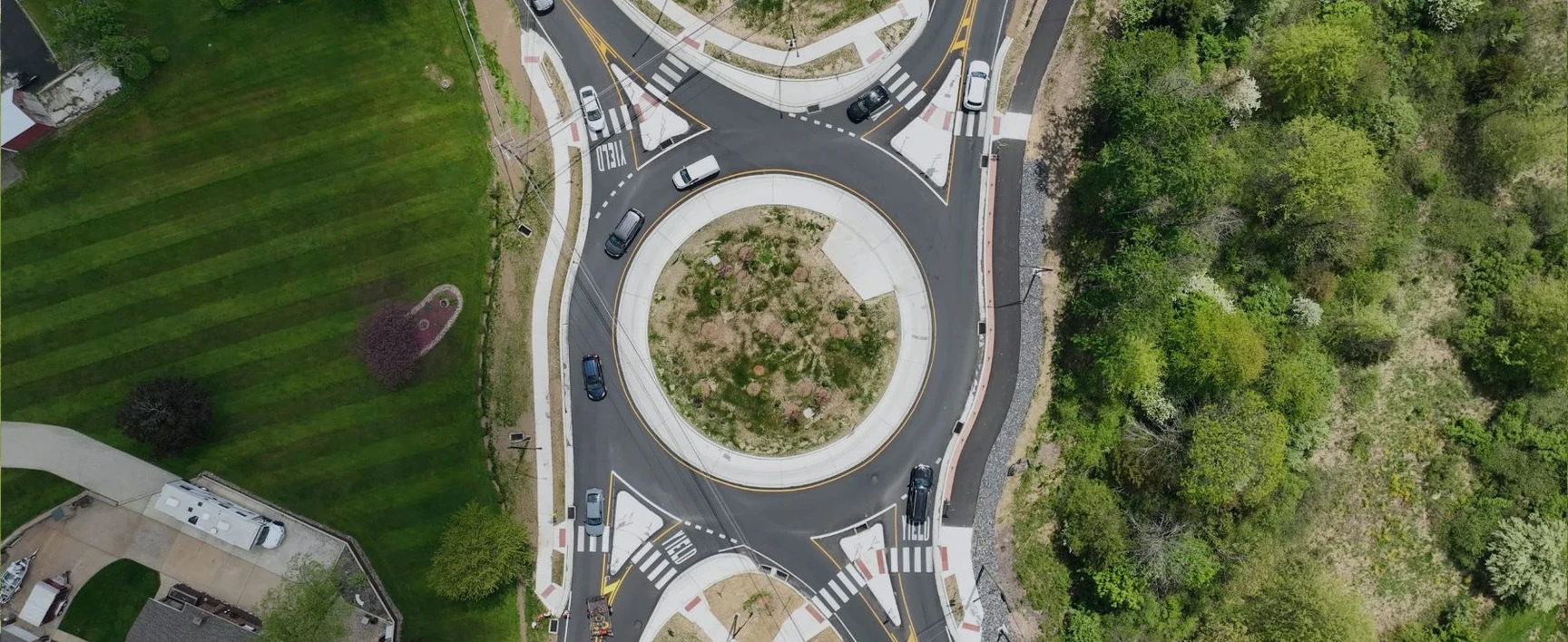 Aerial view of the completed Old Bethlehem Pike/Portzer Road Roundabout project, showing a fully operational single-lane roundabout with landscaped central island