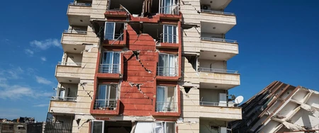 Cracked apartment building facade showing structural damage