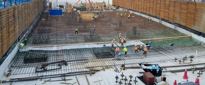 Construction workers installing steel reinforcement