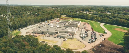 Aerial view of an institutional building under construction with cranes